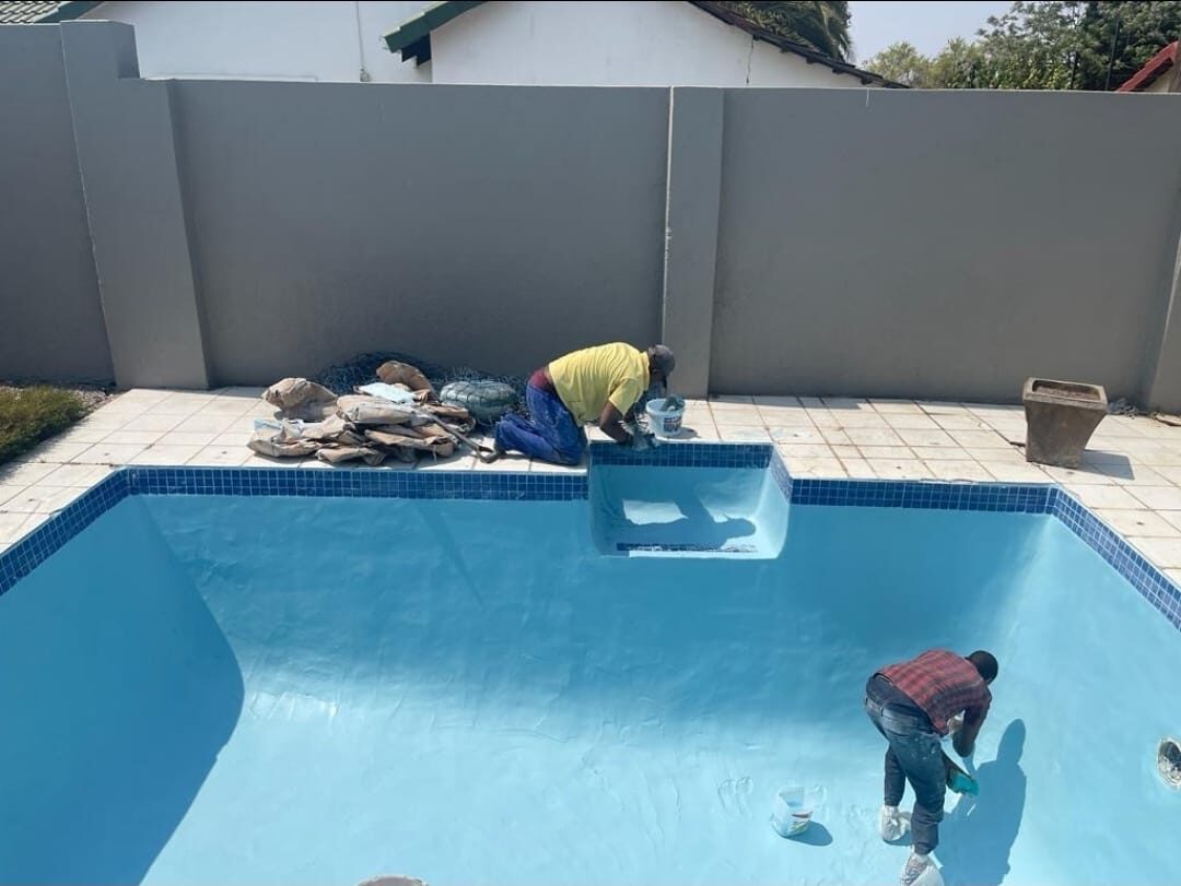 Applying blue plaster during a swimming pool resurfacing job in Randburg